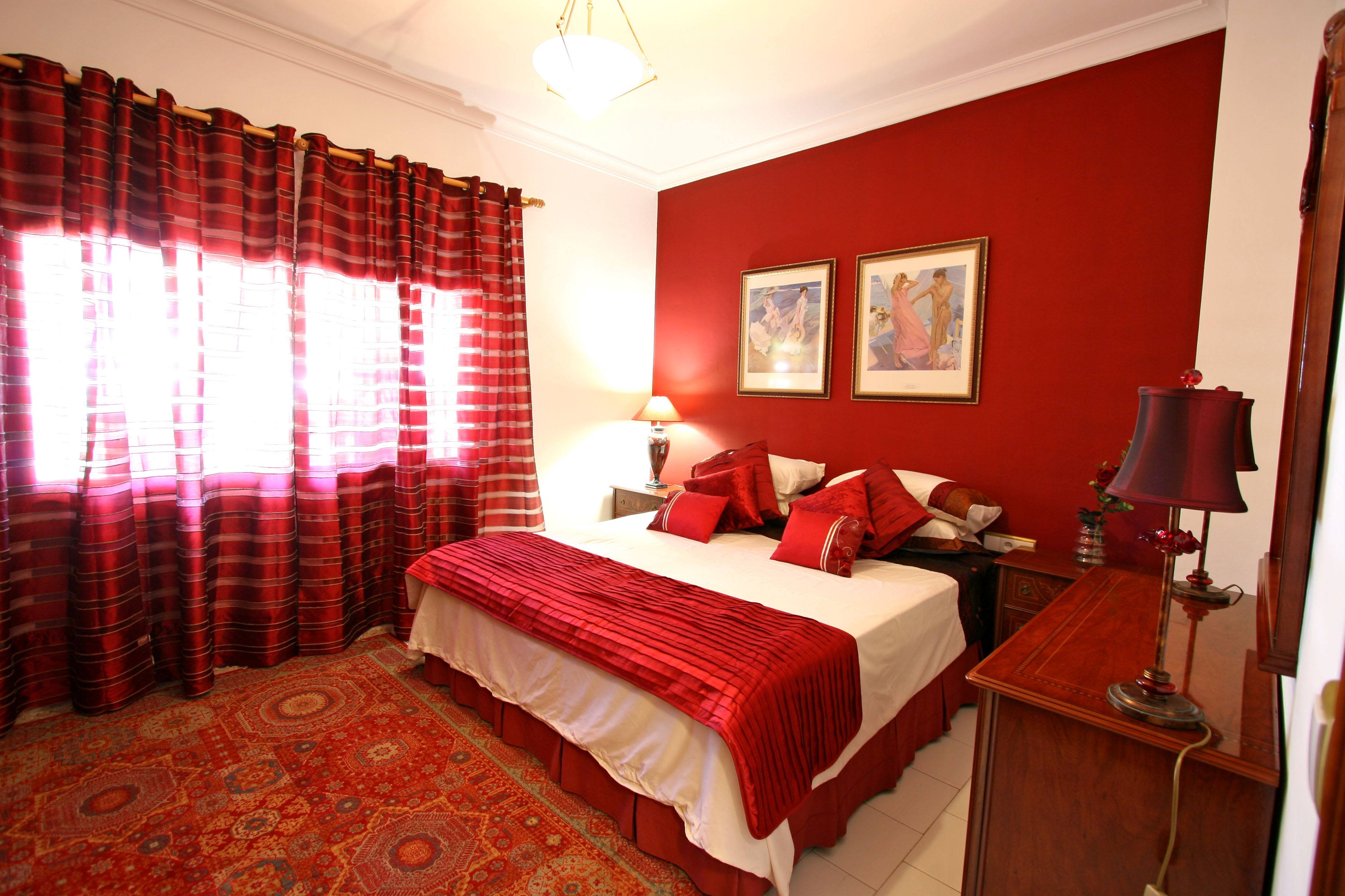Red bedroom with homely appeal.